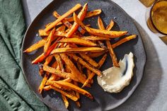 a plate with french fries and dip on it