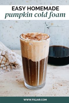 an easy homemade pumpkin cold - foam recipe is shown in a tall glass on a table