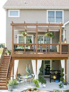 a house with a deck, patio and stairs leading up to the front door area