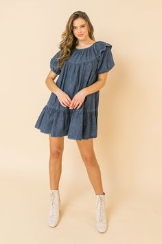 A lightweight denim mini dress featuring round neckline, ruffle at shoulder, puff sleeve, ruffled hemline and keyhole button closure Details Self: 100% Cotton Size & Fit - Model is 5`8" And Wearing Size Small - Measurements Taken From Size Small - Approx. Length: 30.5" Cotton Mini Hem Dress For Brunch, Chic Knee-length Denim Mini Dress, Chic Denim Blue Mini Dress, Dark Wash Denim Mini Dress For Day Out, Trendy Knee-length Dark Wash Mini Dress, Trendy Dark Wash Knee-length Mini Dress, Blue Casual Mini Hem Dress, Trendy Knee-length Denim Blue Mini Dress, Trendy Denim Blue Knee-length Mini Dress