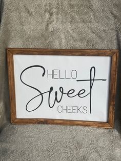 a sign that says hello sweet cheeks on the back of a chair in front of a couch