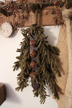 a pine cone is hanging on the wall next to a piece of wood and other decorations