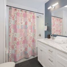 a bathroom with pink and blue shower curtains