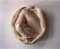 a sculpture of a person's torso in the shape of a circle