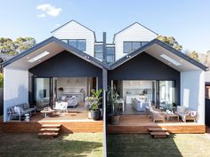 two houses are shown in the middle of an open area with wooden steps leading up to them