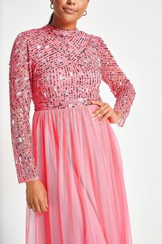 Radiate joy in the strawberry pink Lela. Cut in a minimal long sleeved silhouette, this mid length piece boasts a bodice intricately detailed with sequin and bead embellishment. Style with silver heels and statement earrings for instant special occasion glamour. Contrast Sequin Dresses For Spring Gala, Pink Contrast Sequin Dress For Gala, Long Sleeve Sequin Dresses For Spring, Long Sleeve Embellished Sequin Dress For Party Season, Embellished Long Sleeve Sequin Dress For Party Season, Long Sleeve Sequin Dress With Contrast For Cocktail, Feminine Pink Festive Dress, Spring Midi-length Contrast Sequin Dress, Pink Chic Sequin Evening Dress