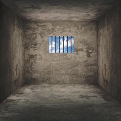 an empty room with bars on the window and cloudy sky in the backround