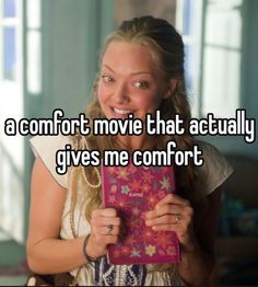 a girl holding a pink box with the words a comfort movie that actually gives me comfort