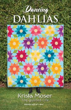 the cover of dancing dahls magazine, featuring an image of a colorful quilt on grass