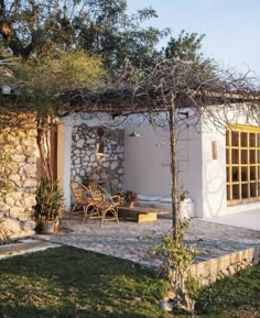 an outdoor living area with stone walls and patio furniture