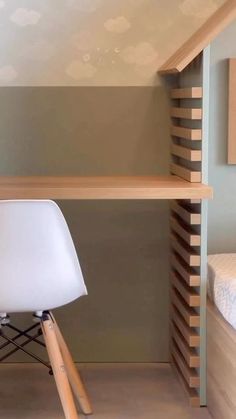 a white chair sitting in front of a desk with a book shelf on top of it