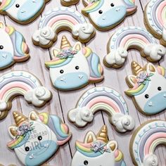 decorated cookies with unicorns and rainbows are on a table next to each other