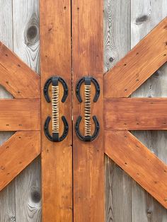 two wooden doors with metal handles on them