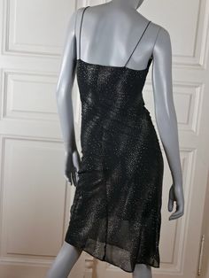 This 1990s French vintage sleeveless evening cocktail dress has sprays of silver crystals throughout, giving it a shimmering look that is sure to get you noticed. The stunning knee-length dress has a V neckline and spaghetti straps. The slimline slip-on dress is lined in black polyamide material. The lining is slightly shorter than the skirt, which gives the lower part of the skirt a beautiful sheer appearance. Bust = 34 inches (86cm) Waist = 27 inches (69cm) Hips = 37 inches (91.5cm) Dress Leng Sparkling Sleeveless Evening Mini Dress, Sleeveless Sparkling Mini Dress For Evening, Sparkling Sleeveless Mini Dress For Evening, Sparkling Sleeveless Summer Evening Dress, Sleeveless Glitter Mini Dress For Gala, Sparkling Sleeveless Cocktail Dress, Sparkling Evening Dress For Summer Cocktail, Summer Cocktail Evening Dress With Sparkling Details, Sparkling Summer Evening Dress For Cocktail