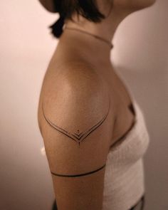 a woman with a tattoo on her shoulder