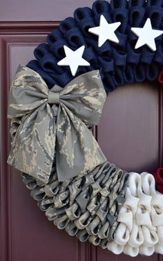 a wreath decorated with stars and bows on the front door for memorial day or veterans day