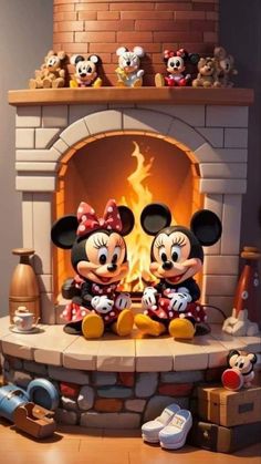 two mickey and minnie mouse figurines sitting in front of a fireplace