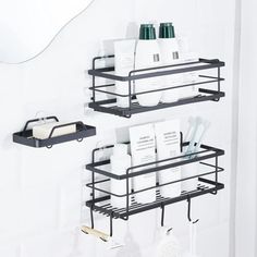 two black metal shelves filled with personal care items next to a mirror in a bathroom