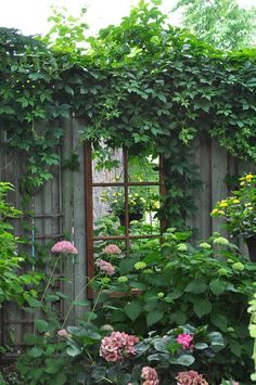 an old shed covered in vines and flowers