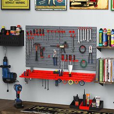 there is a workbench with tools hanging on the wall next to other items