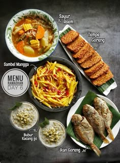 an assortment of food is displayed on a table with names in english and thai writing