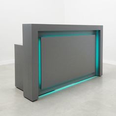 a large gray and blue display case with neon lights on the sides, against a white wall