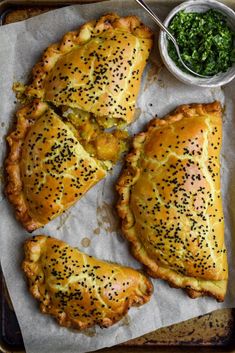 three pieces of bread with sprinkles on it and a bowl of greens