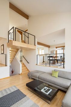 a living room filled with furniture and a staircase