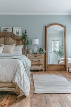 a bed sitting in a bedroom next to a wooden dresser and mirror on top of a hard wood floor