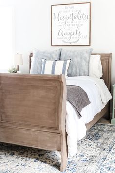 a bed with blue and white pillows in a bedroom