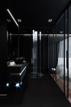 a bathroom with black walls and flooring is lit up by recessed lights that are shining down from the ceiling