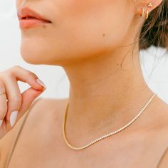 "Our White Crystal Pave Tennis Necklace features dozens of sparkly 2mm crystals along a stunning gold or silver chain. The perfect layering piece to have in your jewelry collection. DETAILS - 2mm white crystal pave stones - 15\" long with a 3\" extender - Available in 14kt gold plated or sterling silver See the matching bracelet here: https://etsy.me/3PE4sBR Packaging + Delivery: All items come packaged in a cute Amanda Deer Jewelry box and are sent in a protective bubble mailer. If ordering mul Dainty Gold Rhinestone Jewelry, Dainty Gold Jewelry With Rhinestones, Gold Tennis Necklace With Diamond Accents As A Gift, Elegant Gold Tennis Necklace With Rhinestones, Gold Cubic Zirconia Tennis Necklace Gift, Gold Crystal Tennis Necklace For Wedding, Gold Tennis Necklace With Rhinestones As A Gift, Gold Tennis Necklace With Rhinestones For Gift, Gold Cubic Zirconia Crystal Necklace With Rhinestones