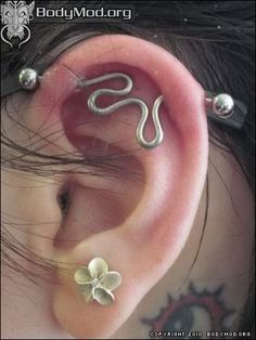 the ear is adorned with two silver flowers