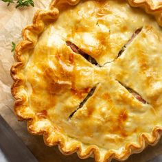 a close up of a pie on a piece of paper with a knife and fork next to it