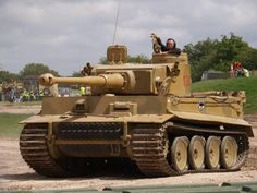 a man is sitting on top of a tank