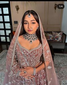 a woman in a wedding dress with jewelry on her neck and veil over her head