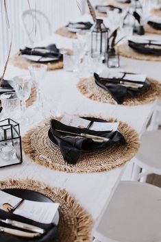 the table is set with black and white place settings