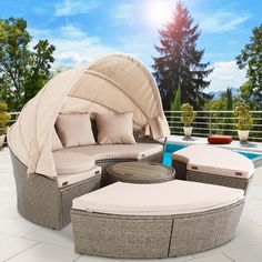 an outdoor furniture set with cushions and pillows on the ground next to a swimming pool