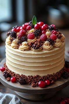 the cake is decorated with berries and nuts