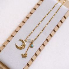 Embrace the enchanting allure of our Vintage Gold Crescent Moon and Butterfly Pendant Necklace, beautifully adorned with a turquoise accent. This unique piece is perfect for those who appreciate intricate details and timeless elegance. Package Includes: 1 x Vintage Gold Crescent Moon and Butterfly Pendant NecklaceElegant gift box Material: 18k gold plated stainless steel Chain necklace Tarnish + water resistant Pendant:18k gold plated stainless steel/Brass/Zircon Chain length: 16 inches+3inches Stainless Steel Chain Necklace, Turquoise Accents, Butterfly Pendant Necklace, Gold Charm Necklace, Butterfly Necklace, Butterfly Pendant, Gold Charm, Steel Chain, Stainless Steel Chain