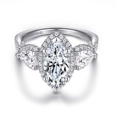 an oval cut diamond ring with three pear shaped diamonds on the band and side stones