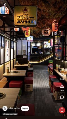 the inside of a fast food restaurant with many tables and benches lined up against the wall