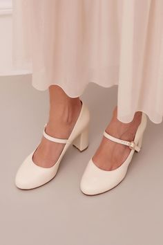 Introducing our Thalia leather heels, an irresistible Mary Jane style meticulously handcrafted from supple leather. These heels showcase a romantic rounded-toe silhouette, making them an ideal choice for brides who desire both style and comfort. Featuring a richly padded leather insole, these ivory shoes are crafted for all-day wear, ensuring you stay comfortable from the ceremony to the dance floor. Beyond your wedding day, the timeless design of the Thalia ivory leather heels makes them a vers Unique Bride Shoes, Wedding Mary Janes, Block Heel Wedding Shoes Brides, Bridal Heels Comfortable, Ivory Wedding Shoes Low Heel, Flat Wedding Shoes For Bride, Low Heel Bridal Shoes, Bridal Shoes Comfortable, Heels For Bride