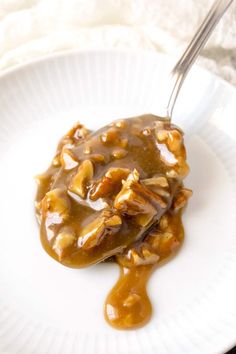 a white plate topped with food covered in gravy