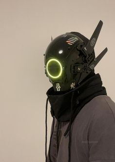 a man wearing a helmet with neon lights on it's face and hood over his head