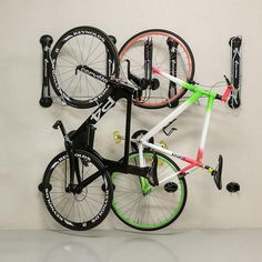 there is a bike mounted to the wall with two bikes on it's rack