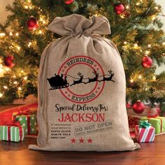 a christmas sack with santa's sleigh on it and presents under the tree