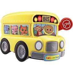 a yellow toy bus with animals on the front and side windows, has a stop sign above it