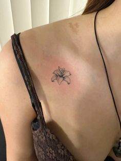 a woman with a flower tattoo on her shoulder