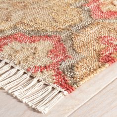 an area rug on the floor with fringes and tassels in different colors